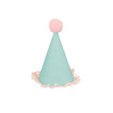 Mini mint green party hat with a pink pom-pom and fringed trim on a white background.