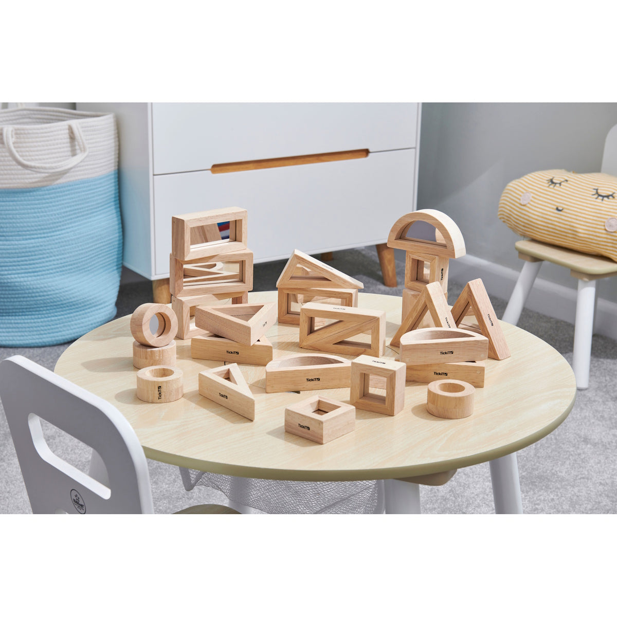 A set of wooden building blocks with mirrored centers, designed to stimulate visual perception, creativity, and block play exploration.