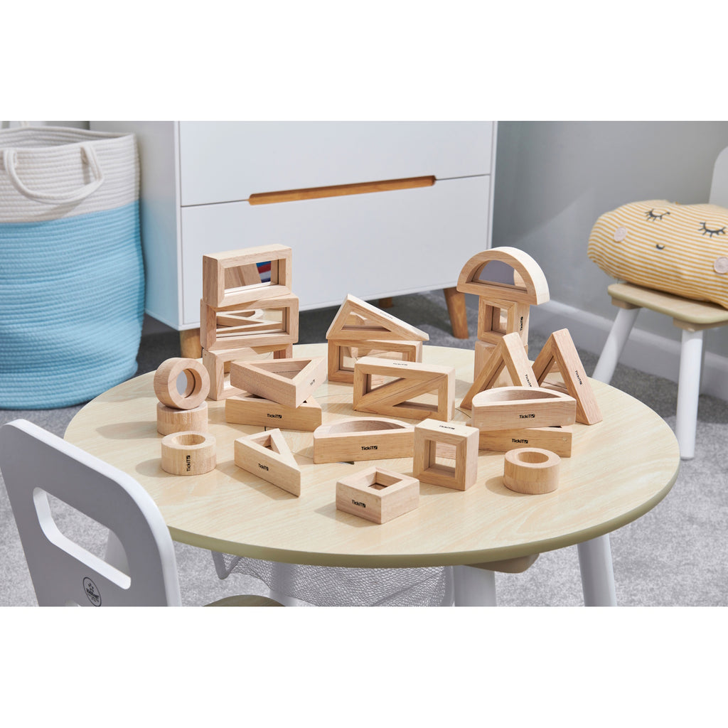 A set of wooden building blocks with mirrored centers, designed to stimulate visual perception, creativity, and block play exploration.