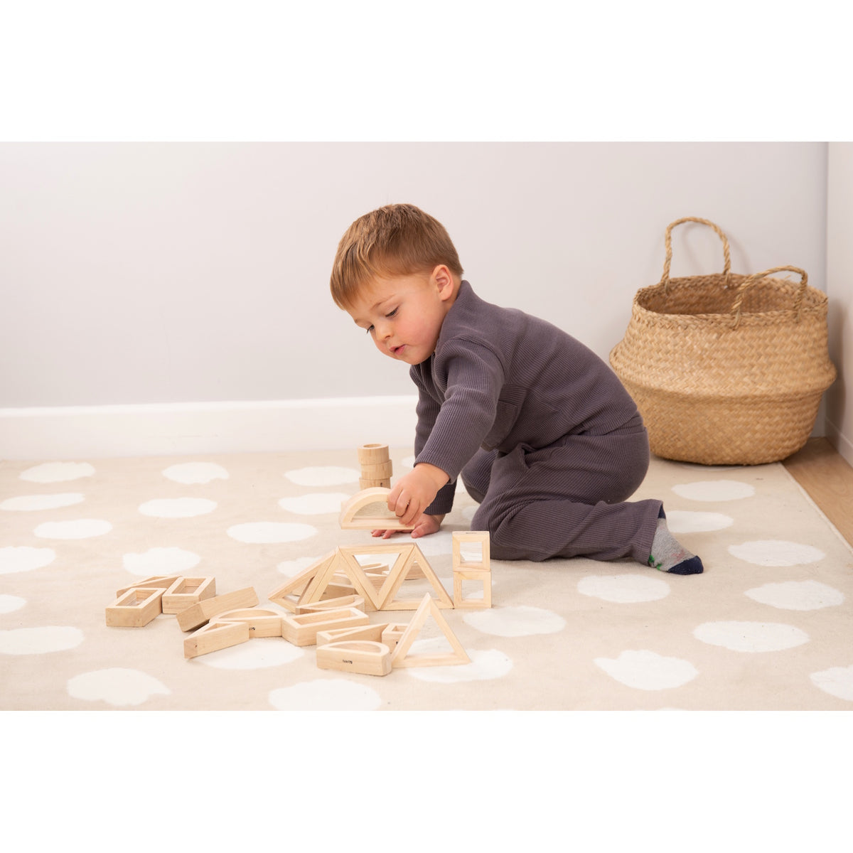 A set of wooden building blocks with mirrored centers, designed to stimulate visual perception, creativity, and block play exploration.