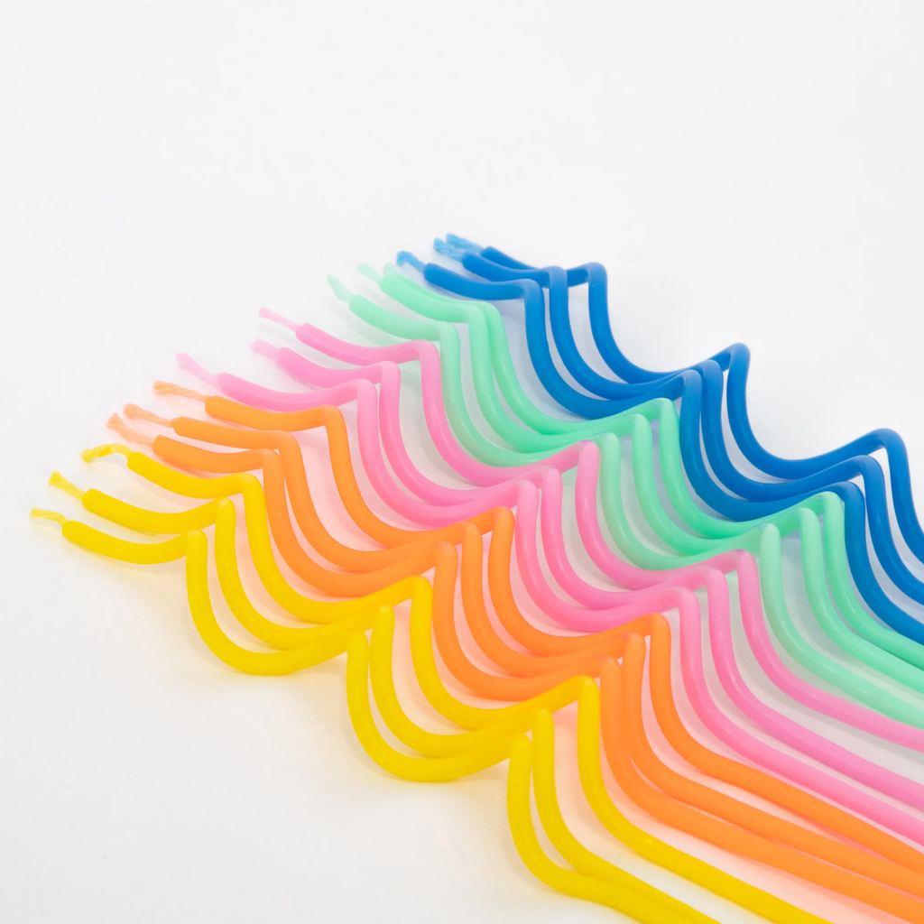 A set of elegant swirl-shaped candles in assorted colors, ideal for adding a stylish touch to cakes and parties.