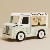Vintage-style light green and white wooden toy cafe van with a serving counter.