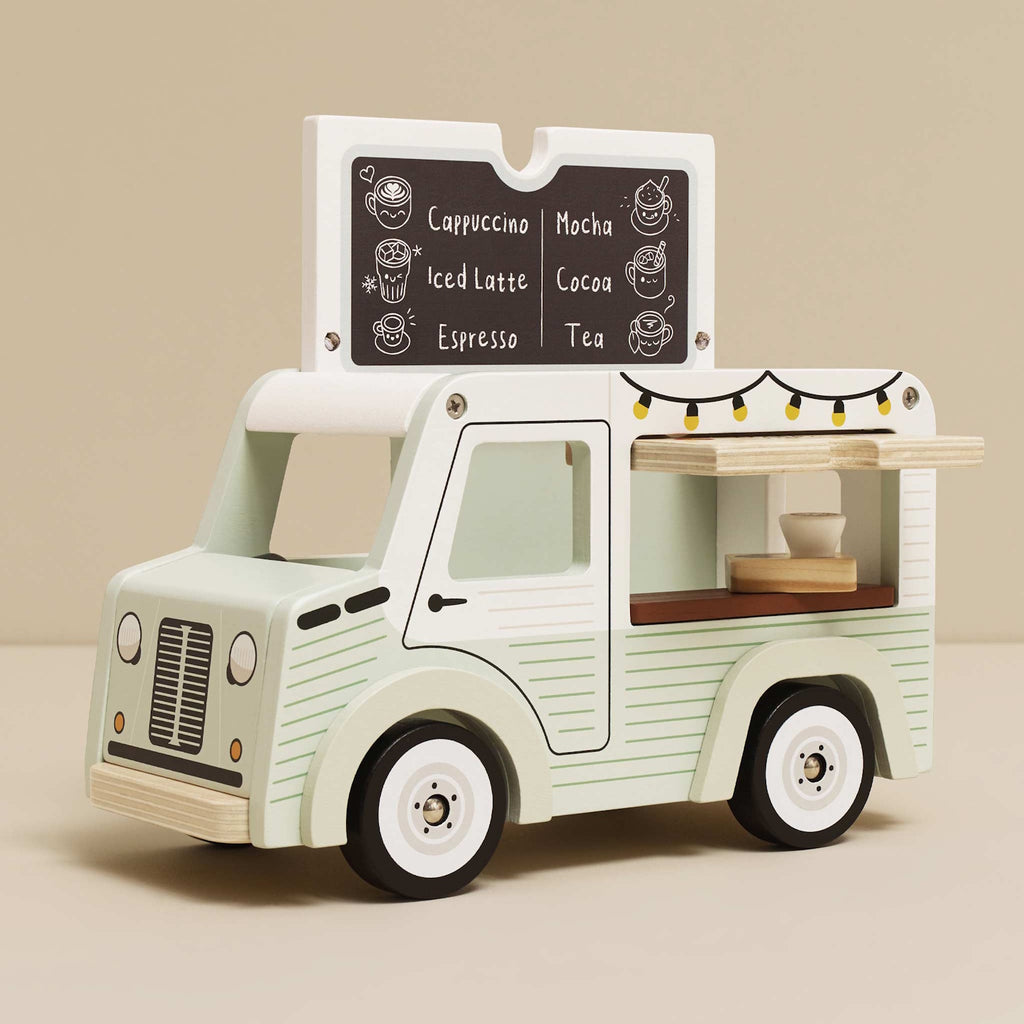 Toy van with a vintage café theme. Light green with cafe signs, decorative lights, and charming details. Whimsical and nostalgic feel.