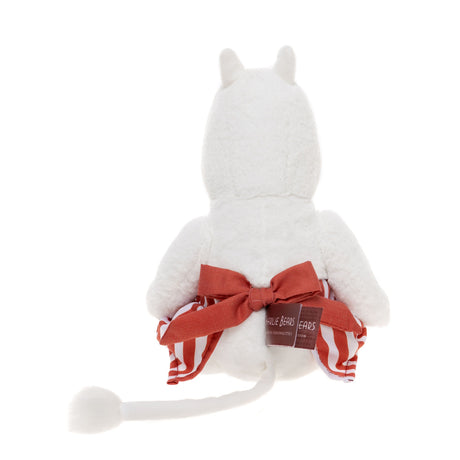 White plush toy seen from the back, wearing a red bow with striped fabric accents. It has a fluffy tail, conveying a cute and playful tone.