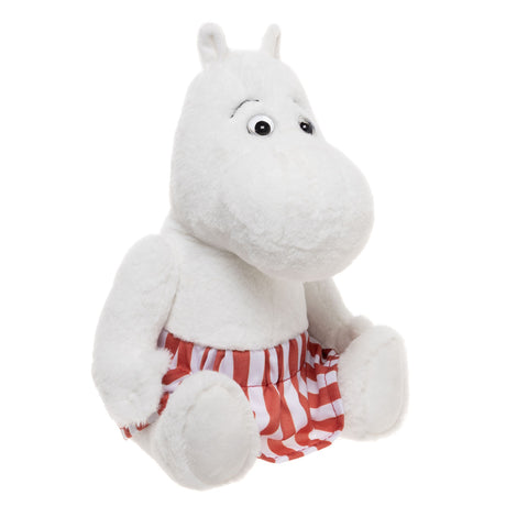 Plush Moomin character in red and white striped pants, sitting upright. Its soft, white fur and wide eyes give a friendly, playful appearance.