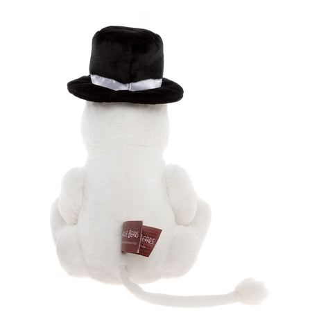 A white plush cat seen from the back, wearing a black hat with a white ribbon. It has a long tail and a tag on its back. The scene is playful.