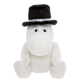 A plush Moomin character sits upright, wearing a large black top hat with a white band. Its expression is friendly, with round eyes.