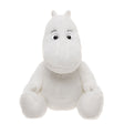 A plush toy resembling a white, hippo-like character sits with a friendly expression. It has round eyes, small ears, and an inviting, soft appearance.