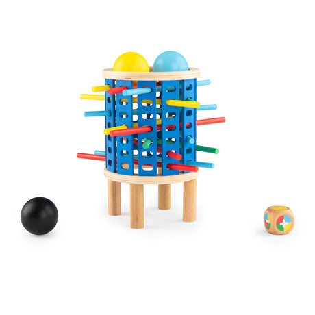 Moulin Roty Giga Bomb wooden game with a blue tower, colorful sticks, balls, and a dice on white background.