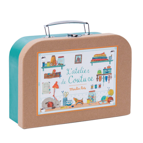 Moulin Roty L'Atelier de Couture kids sewing kit teal kraft suitcase side view with illustrated sewing room.