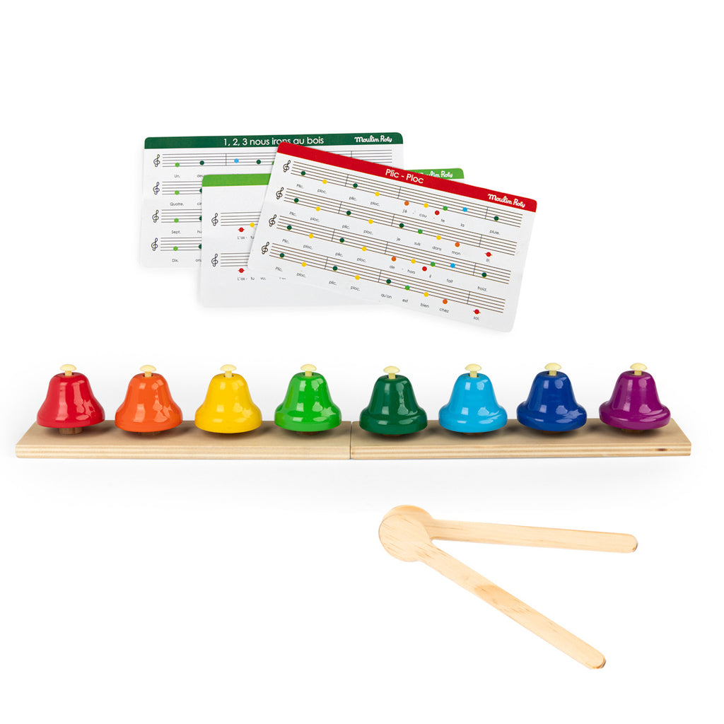A set of colorful bells on a wooden base in rainbow order, with musical note cards in the background and two wooden mallets in the foreground.