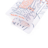 Close up of a flexible, rolled Moulin Roty x SuperPetit silicone coloring mat with animal print.