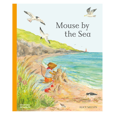 Book cover for "Mouse by the Sea" featuring a mouse building a sandcastle on a grassy beach with flying gulls.