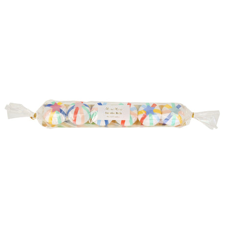 Packaged set of six colorful crepe paper surprise balls lined up inside clear cellophane wrapping with gold ties.