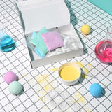 Open Nailmatic Bath Bomb Maker kit with colored powders, molds, mixing bowl, and finished bath bombs.