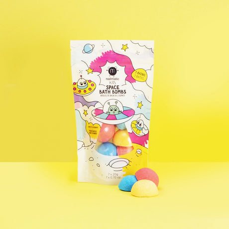 Colorful space-themed bath bomb packaging on a bright yellow background. The playful design features cartoon UFOs and stars, conveying a fun and cheerful vibe.