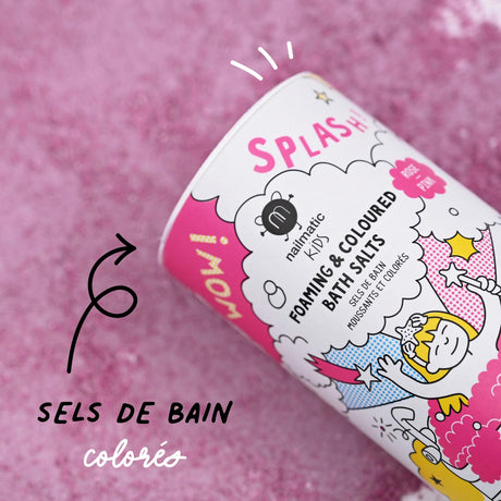 A playful and colorful tube of kids' foaming bath salts lies on a pink textured surface. Vibrant graphics and text emphasize fun and creativity.