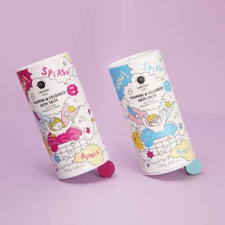Two colorful cylindrical containers of foaming bath salts with playful illustrations are set against a pastel purple background, conveying a fun and lively mood.
