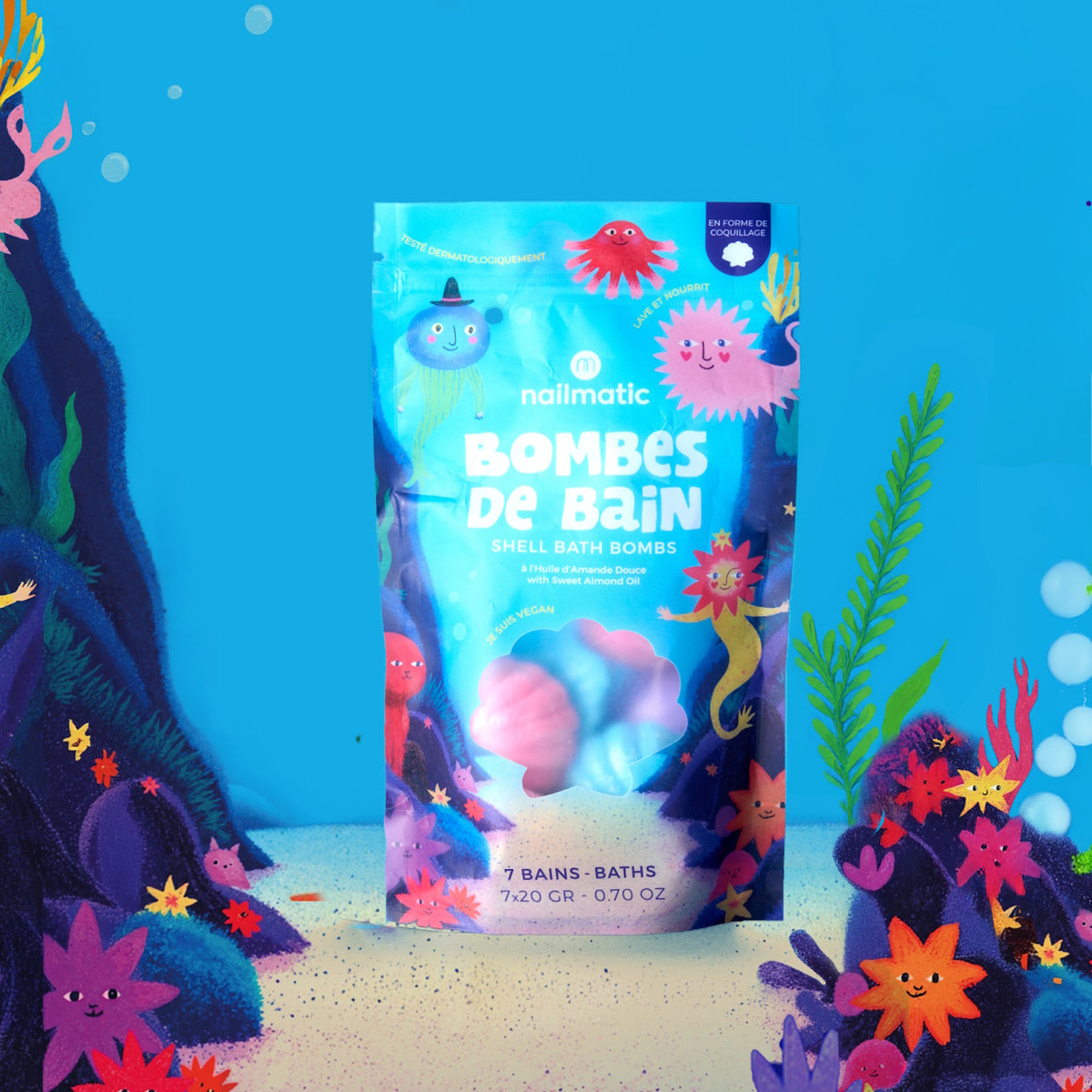 Brightly colored packaging of Nailmatic shell bath bombs on an underwater-themed background. The blue bag features playful, smiling sea creatures.