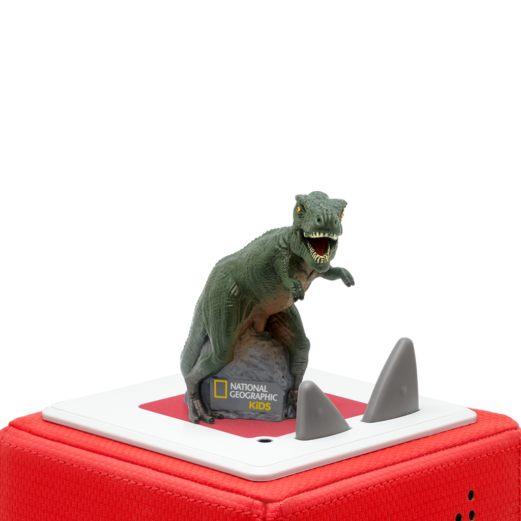 A colorful dinosaur toy, resembling a T-rex, stands on a stone with a National Geographic Kids logo, showcasing its playful design.