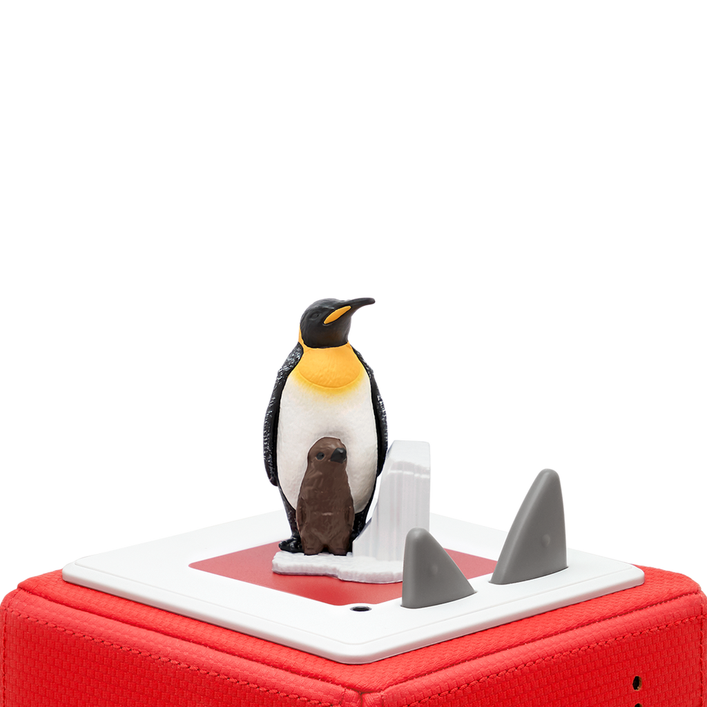 A realistic figurine of an emperor penguin with a brown chick beside it, set against a white ice-like background.