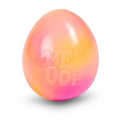 Colorful stress ball with a gradient from orange to pink, branded with "NEE DOH." The glossy surface reflects light, conveying a playful tone.