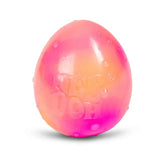 Colorful stress ball with embossed "NEE DOH," blending pink and orange hues. Its smooth, shiny surface is dotted with small droplets, conveying a playful, tactile appeal.