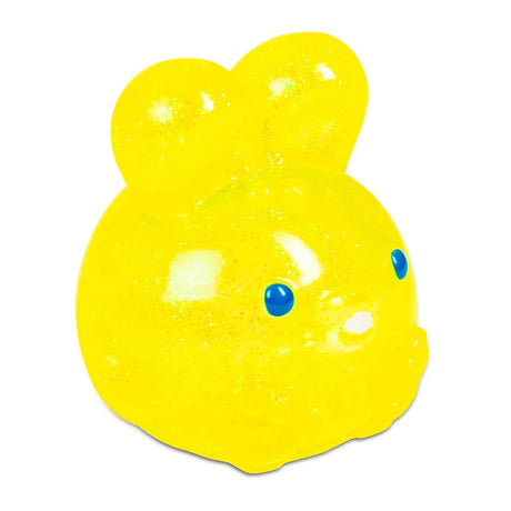 Cheerful yellow bunny-shaped squishy toy with blue eyes, sparkly texture, and two rounded ears. It conveys a playful and fun tone.