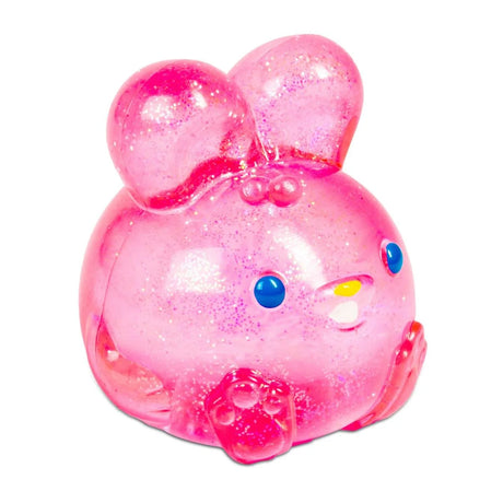 A round, pink, glittery toy resembling a rabbit with big ears, blue eyes, and small paws. Its cheerful and cute design exudes a playful tone.