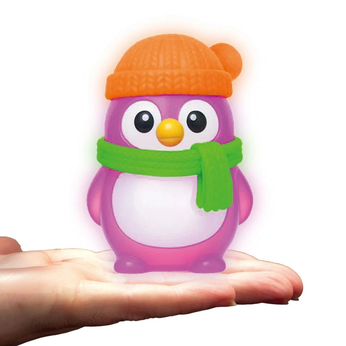 Purple NeeDoh Polar Glow Penguin squishy toy with orange beanie and green scarf sitting on a person's palm.