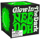 Black box with bold, glowing green text "Glow In The Dark Nee Doh" on the side. Warning label about choking hazard for ages 3 and up accentuates safety concern.