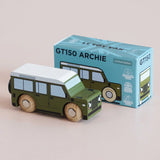 Front three-quarter view of a green wooden toy car displayed alongside its light blue packaging box.
