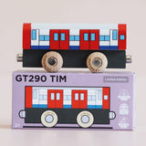 Red, white, and blue wooden toy train carriage resting on top of its matching GT290 TIM product box.