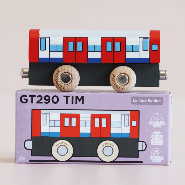 Red, white, and blue wooden toy train carriage resting on top of its matching GT290 TIM product box.