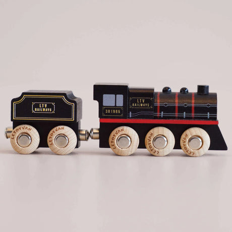 Side view of black wooden toy steam train with LTV Railways branding and natural wood wheels.