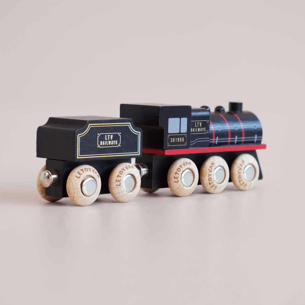 Rear view of black wooden toy steam train with tender and LTV Railways branding.