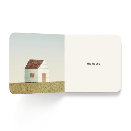 Minimalist children's book page featuring a simple house illustration and the text "the house".