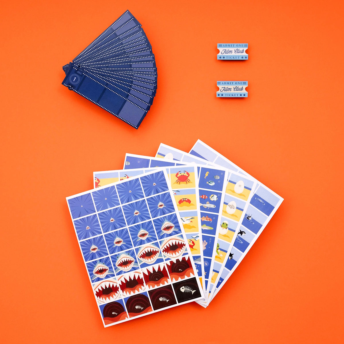 Ocean flip book animation kit featuring sea life frame sheets, film strips, and tickets on orange.