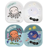Inside pages of Wee Gallery bath book showing black and white sea creatures that change to color when wet.