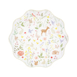A scalloped paper plate decorated with pastel watercolor illustrations of woodland animals and wildflowers.