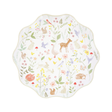 A scalloped paper plate decorated with pastel watercolor illustrations of woodland animals and wildflowers.