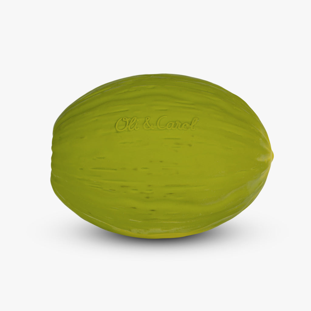 A realistic, bright green watermelon-shaped toy against a plain white background. Textured surface mimics a melon, and "Oli & Carol" is subtly embossed.