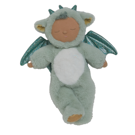 Plush baby doll in a green dragon onesie with sparkly wings and horns. The doll's eyes are closed, and it conveys a peaceful, sleepy expression.