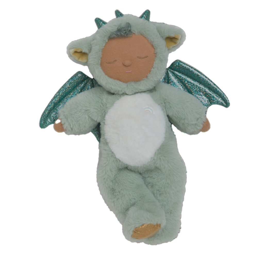 Plush baby doll in a green dragon onesie with sparkly wings and horns. The doll's eyes are closed, and it conveys a peaceful, sleepy expression.