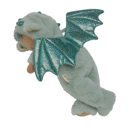 Plush baby doll in a green dragon onesie with sparkly wings and horns. The doll's eyes are closed, and it conveys a peaceful, sleepy expression.