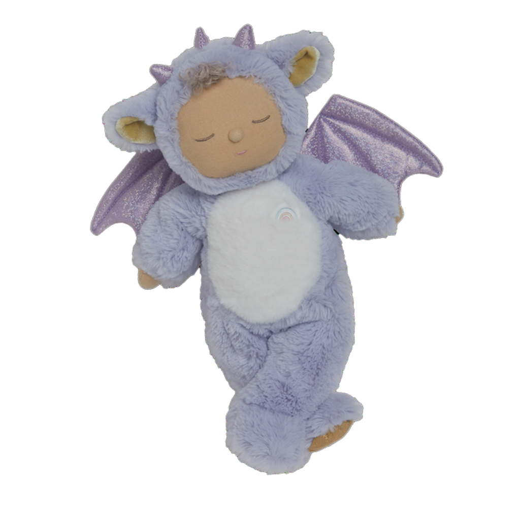 Cute plush doll in a purple dragon costume with sparkly wings. The doll has a serene expression, curly hair, and a small rainbow emblem.
