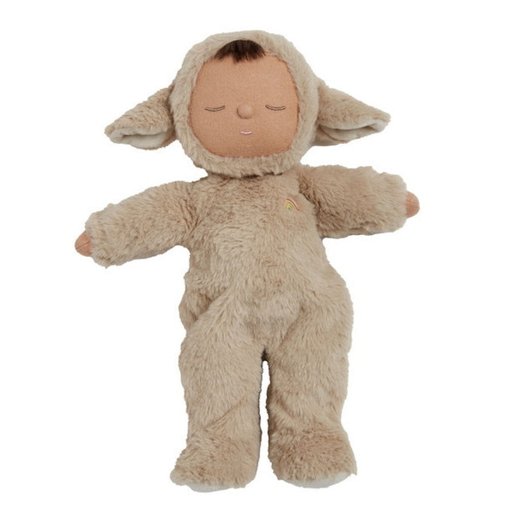Cute doll in a fluffy beige sheep costume with floppy ears and a serene face. The doll wears a small embroidered rainbow, conveying calmness.