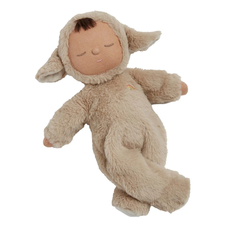 Cute doll in a fluffy beige sheep costume with floppy ears and a serene face. The doll wears a small embroidered rainbow, conveying calmness.