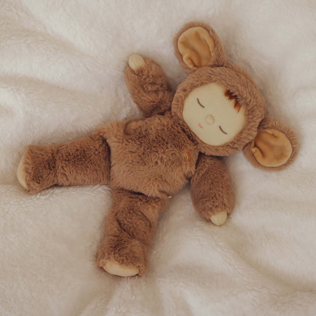 A plush toy dressed in a soft, brown mouse suit with large ears. The toy's serene expression and closed eyes convey a sense of calm.