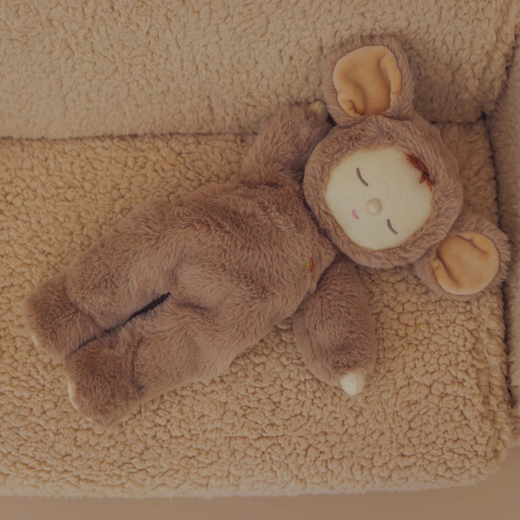 A plush toy dressed in a soft, brown mouse suit with large ears. The toy's serene expression and closed eyes convey a sense of calm.